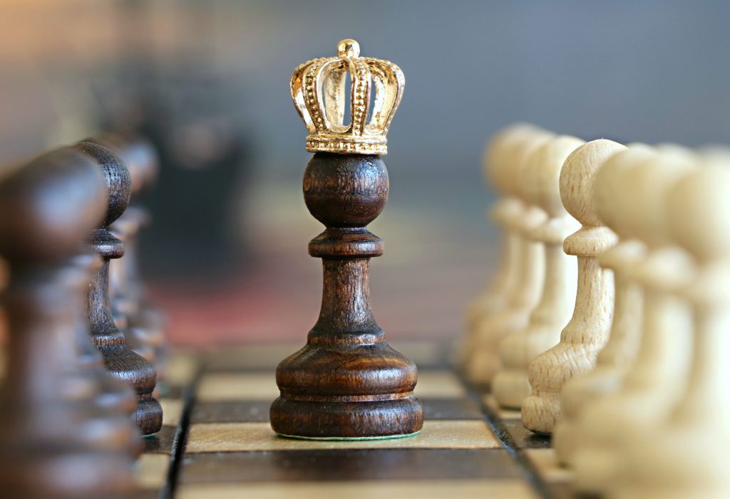 competitive chess pawn wearing a crown