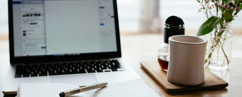 A computer and a cup of coffee, the tools us using the advantages of multiple marketing sources