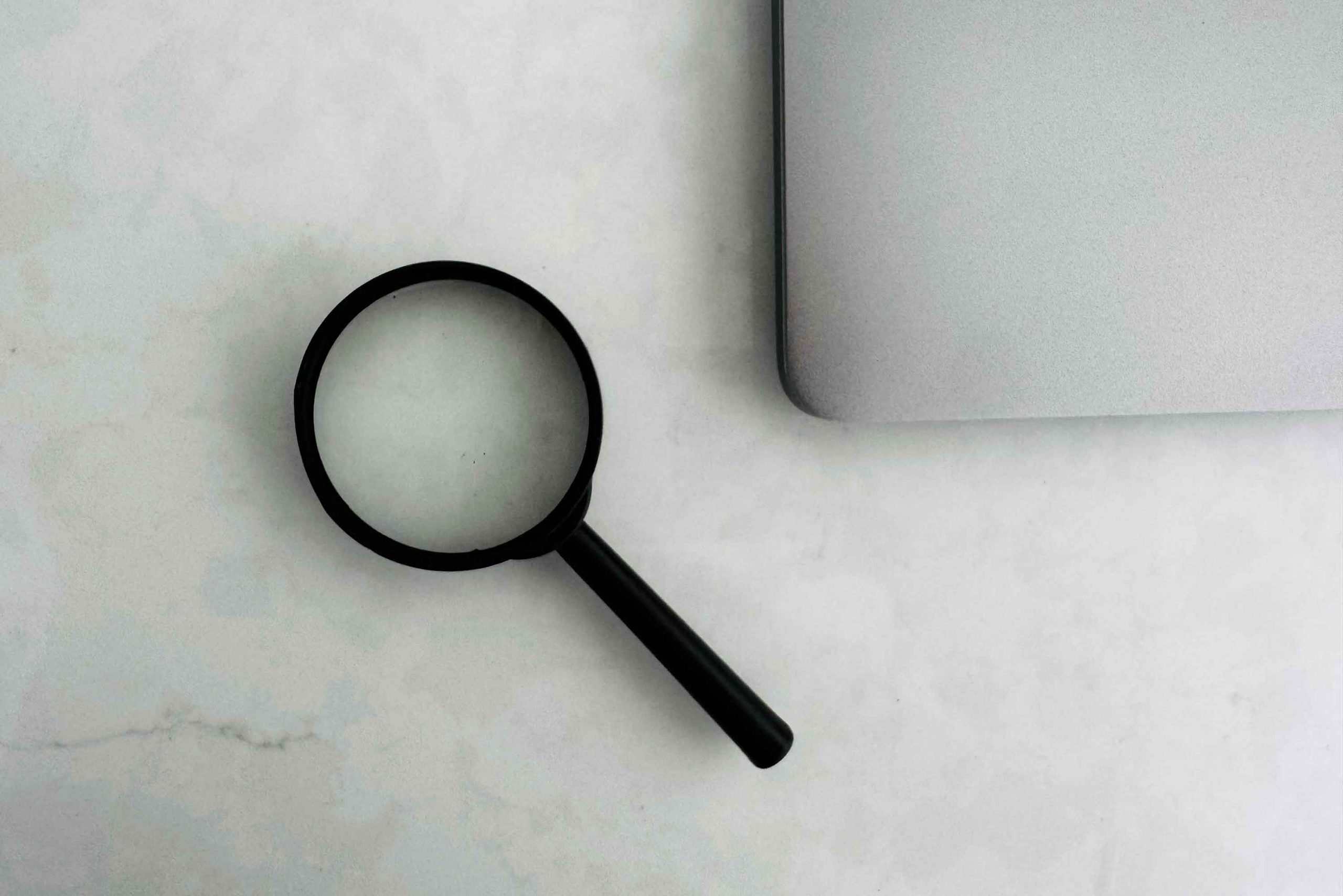 magnifying glass and a laptop corner